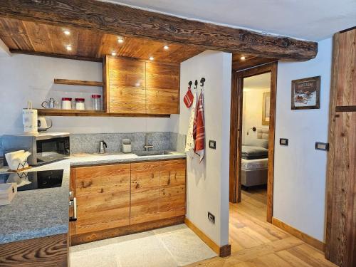 a kitchen with wooden cabinets and a sink at Maison Martin in Pré-Saint-Didier