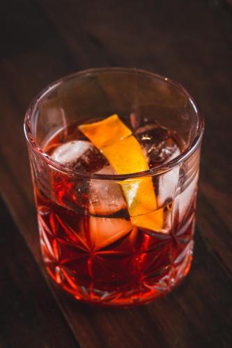 a glass of drink with ice and orange cubes at Pousada Cantelli in Bento Gonçalves