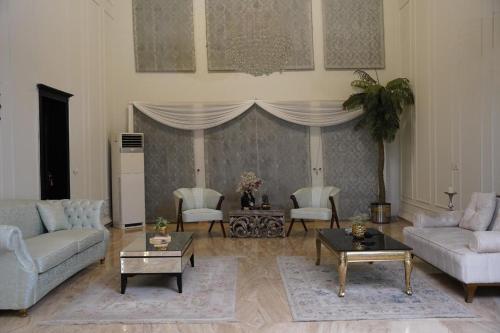 a living room with two couches and a table at Grace Boutique Hotel in Islamabad