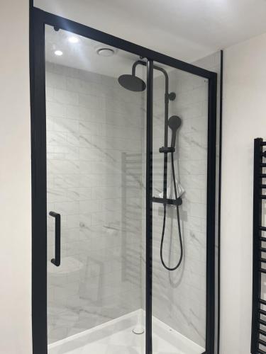 a shower with a glass door in a bathroom at The Studio, Arundel in Arundel