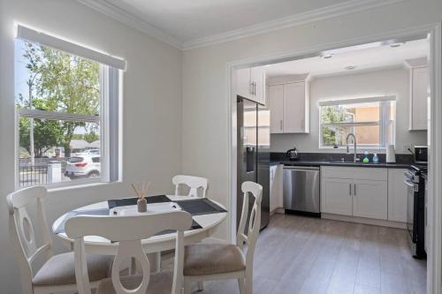 a kitchen and dining room with a table and chairs at Serene Home in Central Burbank in Burbank