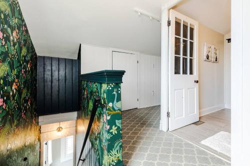 a living room with a green trash can at Lux 4BR Townhome - City Views - Free Parking in Cincinnati