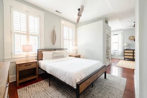 a bedroom with a bed and a desk and windows at Lux 4BR Townhome - City Views - Free Parking in Cincinnati