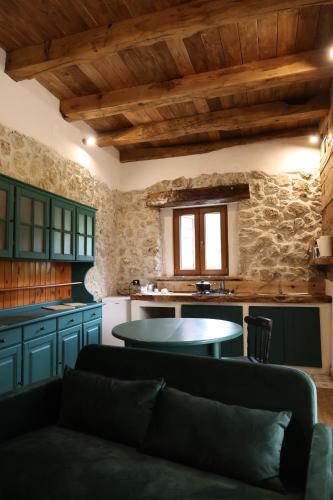 a kitchen with a couch and a table in a room at Dimore Di Charme Lago Matese in San Gregorio