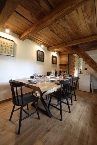 a dining room with a large wooden table and chairs at Dimore Di Charme Lago Matese in San Gregorio