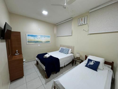 Giường trong phòng chung tại Pousada Vila Praiana