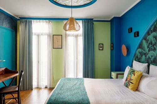 a bedroom with blue and green walls and a bed at Villa Bougainville by Happyculture in Nice