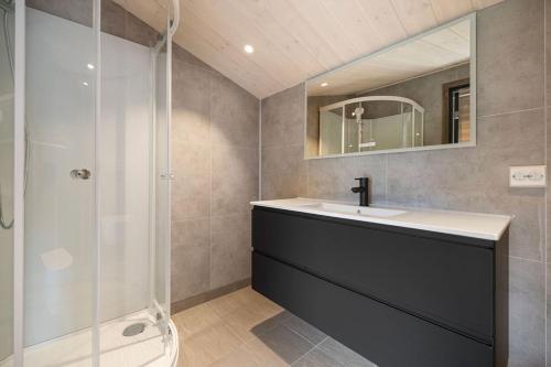 a bathroom with a sink and a shower at Mountain View Apartment - penthouse in Stranda