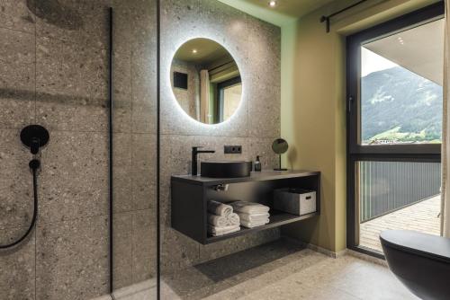 a bathroom with a sink and a mirror at Zellrooms in Zell am Ziller