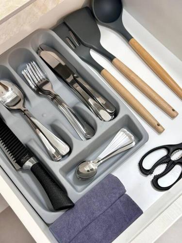 a tray with silver utensils in a drawer at URBAN Georgetown 9Pax 4QueenBed 3Bedroom 2Bath 2carparks in Jelutong