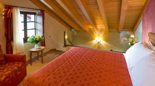 a bedroom with a red bed and a window at Maison Cly in Chamois
