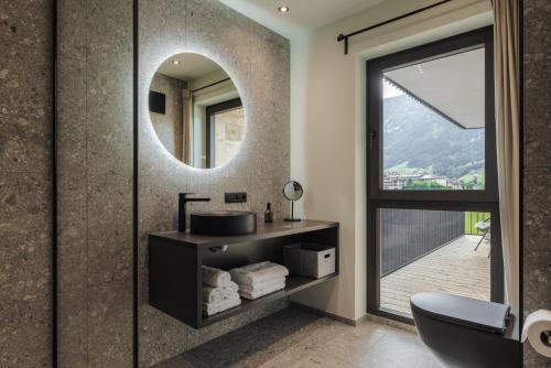 a bathroom with a sink and a mirror at Zellrooms in Zell am Ziller