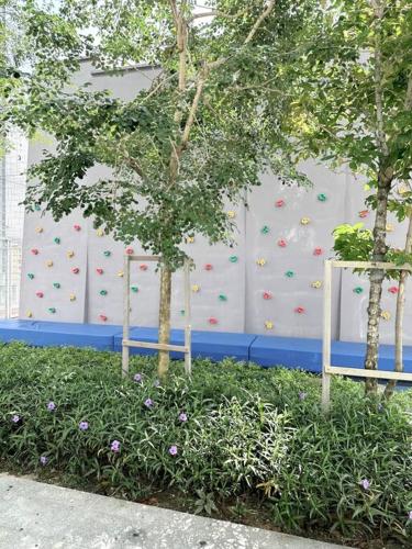 two trees in front of a climbing wall at URBAN Georgetown 9Pax 4QueenBed 3Bedroom 2Bath 2carparks in Jelutong