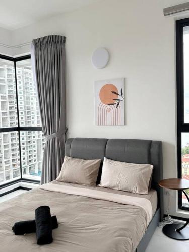 a bed in a room with a large window at URBAN Georgetown 9Pax 4QueenBed 3Bedroom 2Bath 2carparks in Jelutong