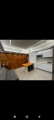 a kitchen with a wooden table in a room at Suite ejecutiva en el CCCT in Caracas