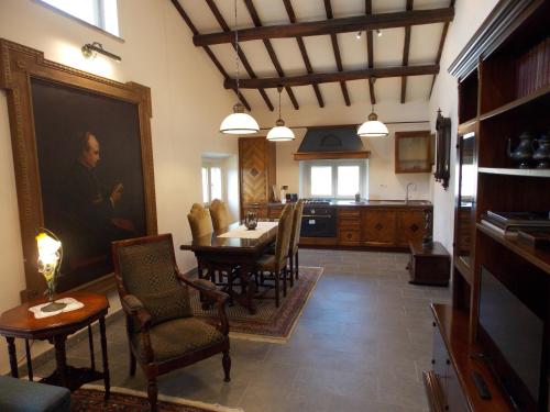 a living room with a table and a kitchen at Il Rifugio del Vescovo in Vetralla
