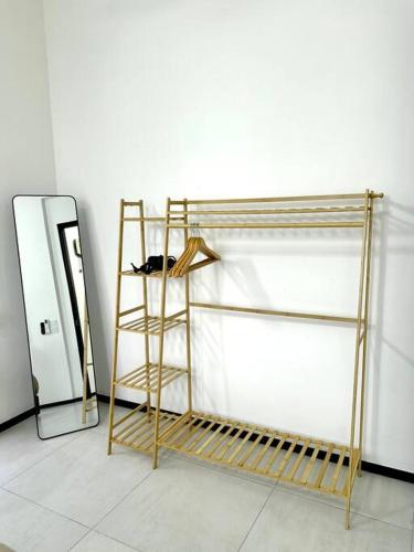 a wooden shelf next to a mirror in a room at URBAN Georgetown 9Pax 4QueenBed 3Bedroom 2Bath 2carparks in Jelutong