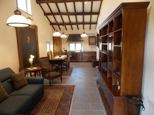 a living room with a couch and a dining room at Il Rifugio del Vescovo in Vetralla