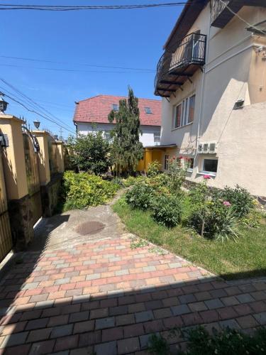 a brick walkway in front of a building at Vila Mirela in Şura Mică