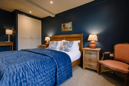 a bedroom with a bed and a chair at The Crown, Bildeston in Bildeston