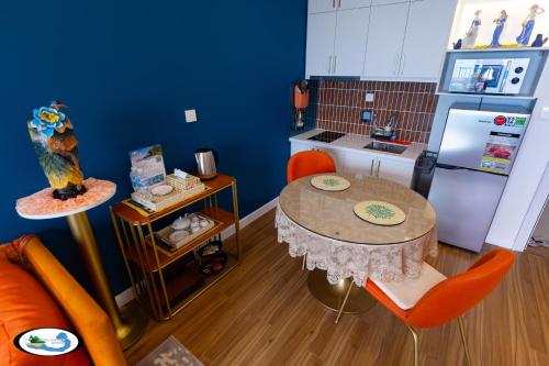 a small kitchen with a table and a refrigerator at Oscar Seaview Apartment in Phu Quoc