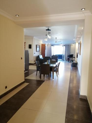 a living room and dining room with a table and chairs at Sunset View La Cote D 'Azure in Pereybere