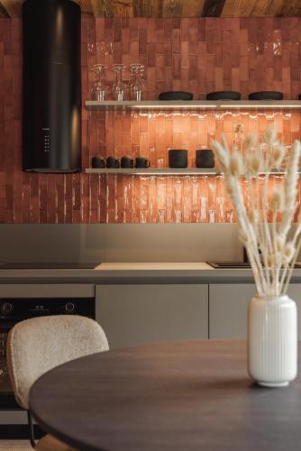 a kitchen with a table and a counter with a stove at Zellrooms in Zell am Ziller