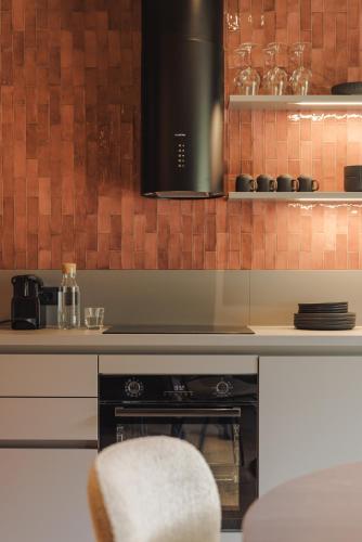 a kitchen with a stove and a counter top at Zellrooms in Zell am Ziller