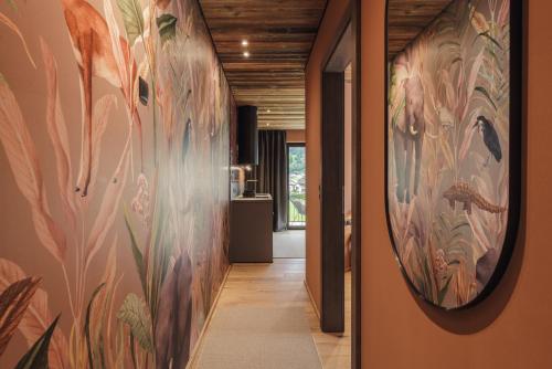 a hallway with a large painting on the wall at Zellrooms in Zell am Ziller