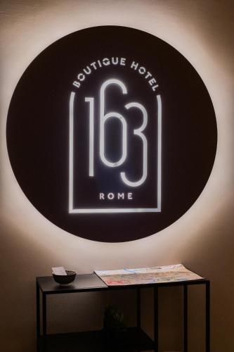 a black and white sign on a wall at 163 BOUTIQUE HOTEL in Rome