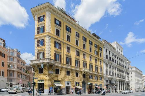 a yellow building on the corner of a street at 163 BOUTIQUE HOTEL in Rome