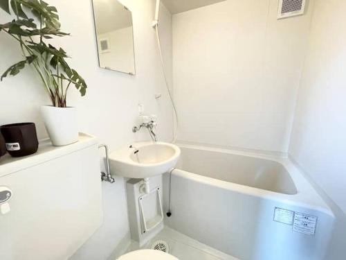 a bathroom with a sink and a toilet and a bath tub at C3 Shinjuku center-4mins to room 10min to Kabukicho-新宿商圈Loftoom in Tokyo