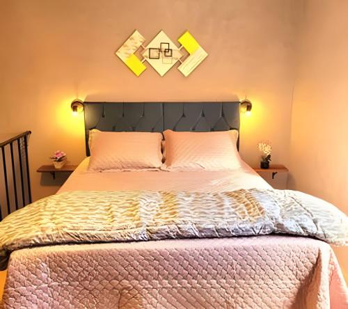 a bedroom with a bed and two pictures on the wall at Laguna Lofts in Poços de Caldas