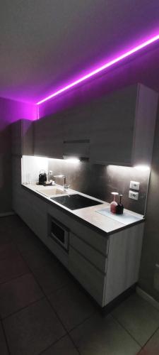 a kitchen with purple lights on the counters at Diamond Suite Verona in Verona
