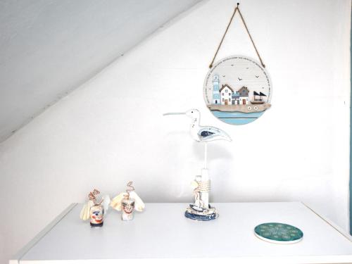 a shelf with a mirror and some figurines on it at 2 Bed in Anstruther 80648 in Pittenweem