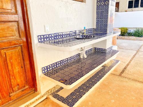 a bathroom with blue and white tile on the wall at Casa Saltwater Cowboy En La Playa - Beachfront Property in Chuburná