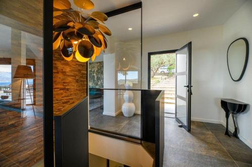 a dining room with a chandelier in a house at Les Terrasses de Fromentica in Saint-Florent