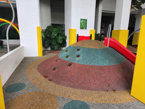a playground in a building with a red slide at Antara Lima Homestay Putrajaya in Putrajaya