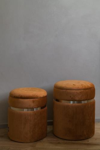 two wooden stools sitting next to a wall at 163 BOUTIQUE HOTEL in Rome