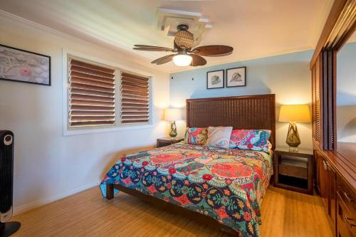 a bedroom with a bed and a ceiling fan at Hanalei Colony Resort I-2 in Hanalei