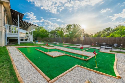 a miniature golf course in the backyard of a house at Luxury 6br Home, Game Room By Lackland & Seaworld in San Antonio