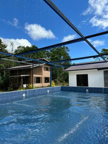 a pool of water in front of a house at LVG Paradise Resort and Events in Mendez-Nuñez