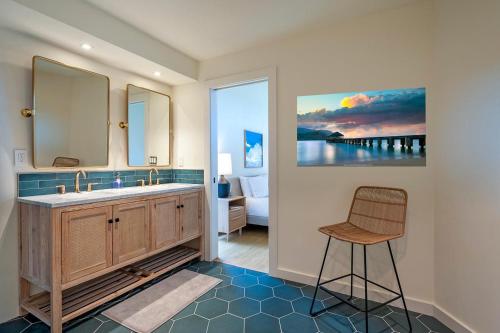 a bathroom with a sink and a chair in it at Mauna Kai 5B in Princeville
