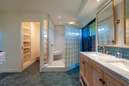 a bathroom with two sinks and a walk in shower at Mauna Kai 5B in Princeville