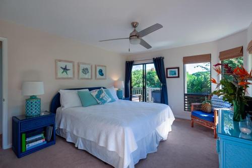 a bedroom with a large bed and a window at Hanalei Bay Villa 26 in Princeville