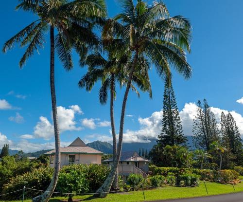 two palm trees in front of a house at Hanalei Bay Villa 26 in Princeville