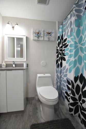 a bathroom with a toilet and a sink at Modern Loft wQueen Loft Steps to Beach in Hollywood