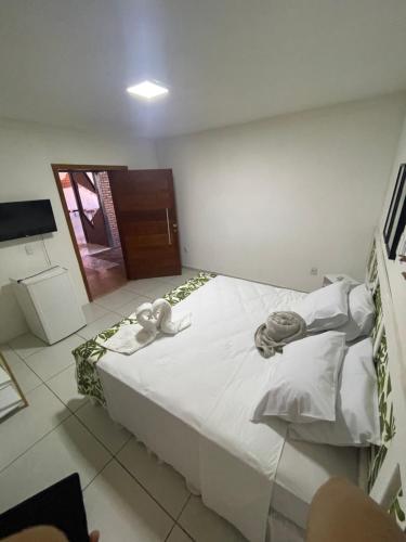 a bedroom with a bed with two stuffed animals on it at Casarao da Terra in Prado