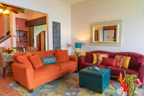 a living room with two couches and a table at Sealodge C7 in Princeville
