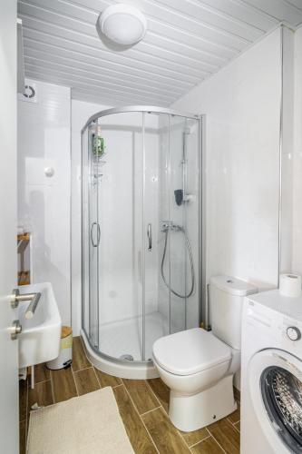 a bathroom with a shower and a toilet and a sink at Gracija in Jagodina